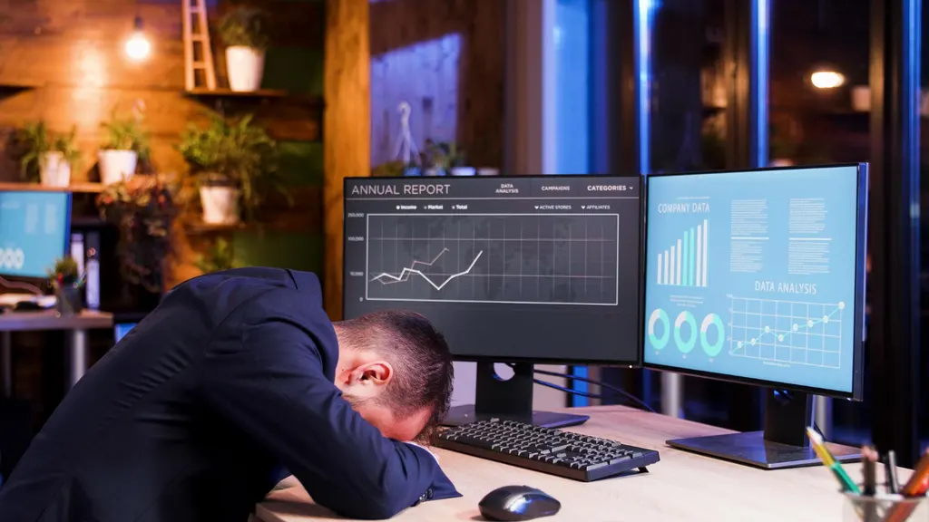 Person reviewing a savings account statement next to a laptop showing bank balances